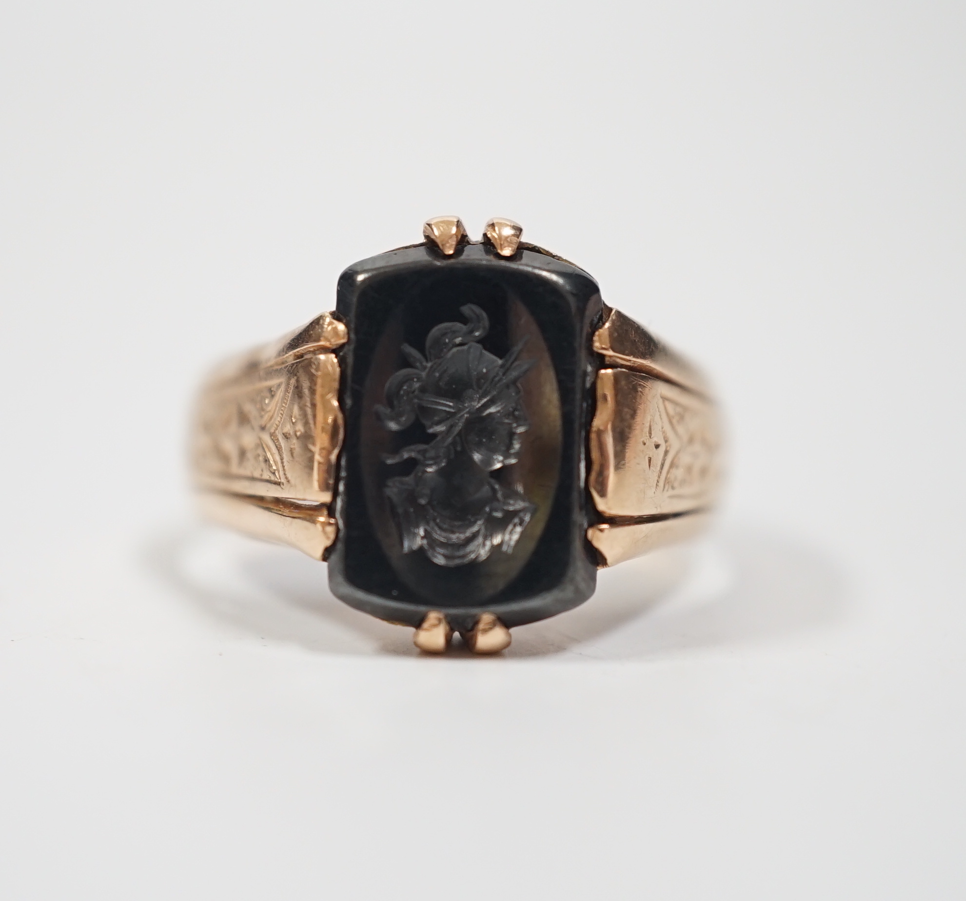 A 585 yellow metal and intaglio hematite set ring, carved with the bust of a gentleman to sinister, size S/T, gross weight 5.6 grams.